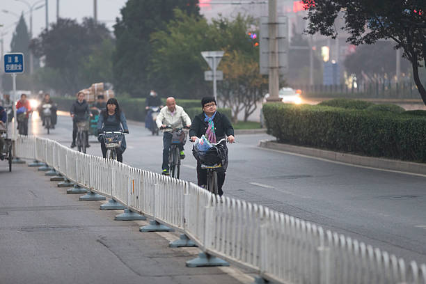 Beijing, China - October 18, 2016: People are ride bicycle to work on the street.