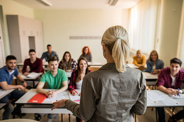 istock Back view of teacher during a lecture in the classroom. 619505442