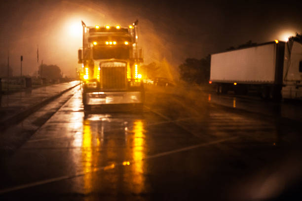 istock Nighttime Expressway Rest Stop Bright Lights Semi Trailer Truck 619505620