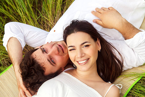 istock Happy young smiling couple on the summer meadow 619505626