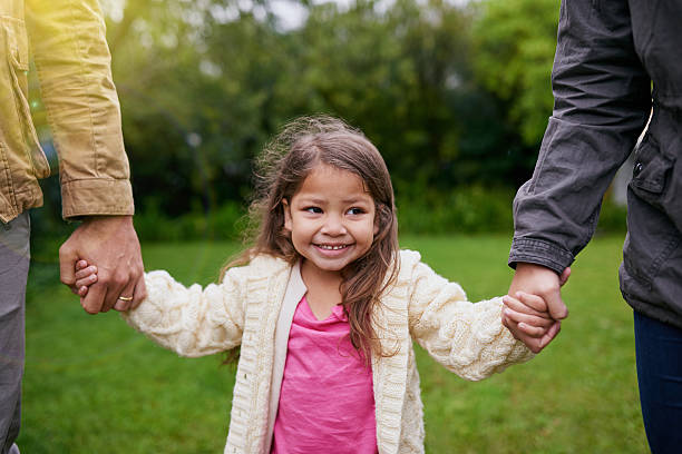 istock Safe in the hands of her parents 619509092