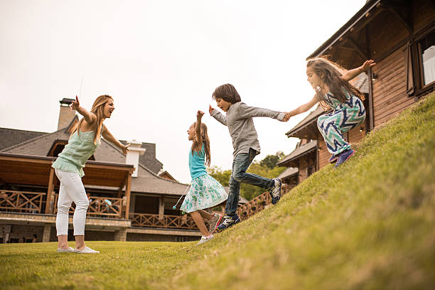 istock Playful children having fun with their mother in nature. 619509328
