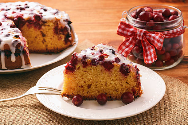 istock Cranberry cake with icing on brown wooden background. 619509480