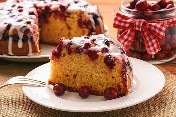istock Cranberry cake with icing on brown wooden background. 619509506
