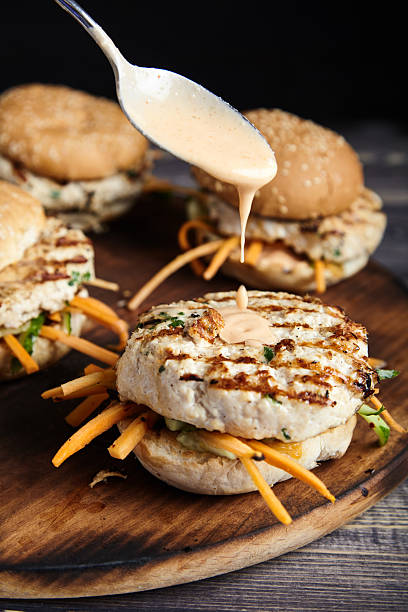 istock Homemade burgers Thai-style on cutting board 619510318