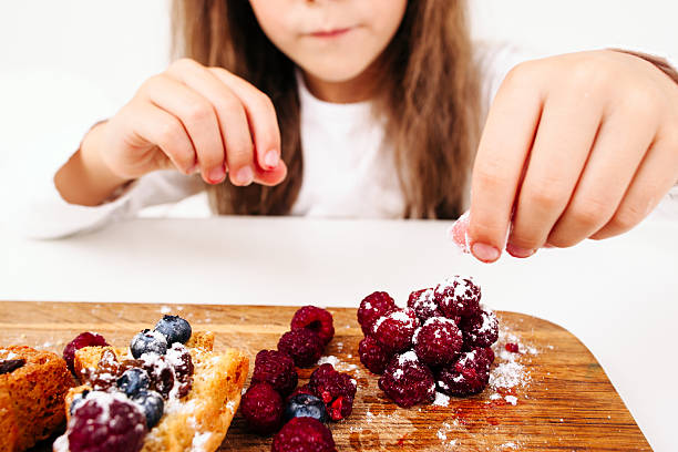istock Unrecognizable girl decorating pastry close-up 619510716