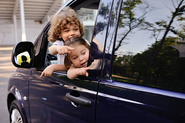 istock children look out from a car window 619511968