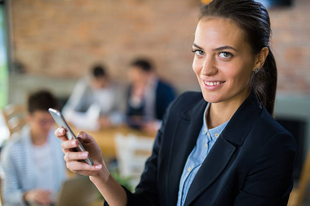 istock Young smiling businesswoman typing text message 619512962