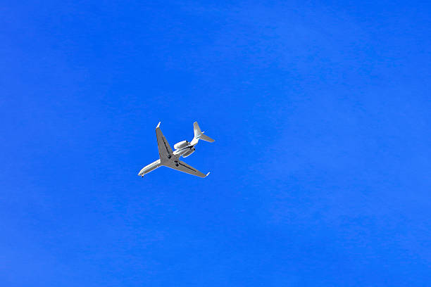 istock Low angle view of airplane flying in clear sky 619513878