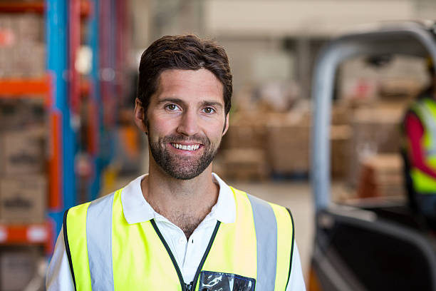 istock Portrait of smiling warehouse worker 619514440