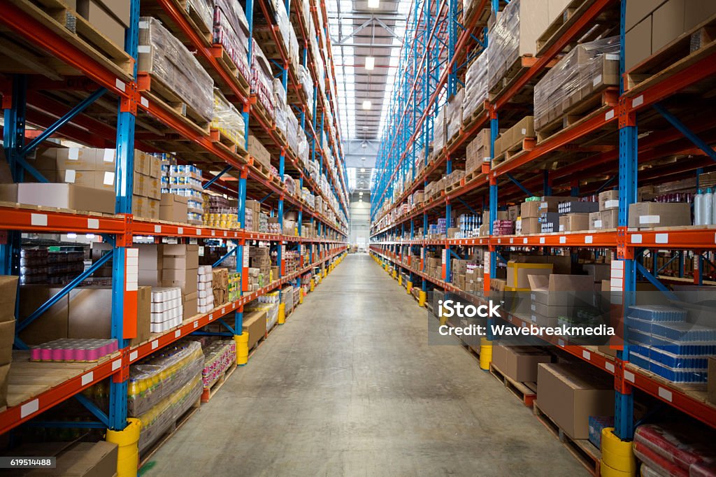 Boxes kept on shelves in the warehouse Boxes kept on row of shelves in the warehouse Warehouse Stock Photo