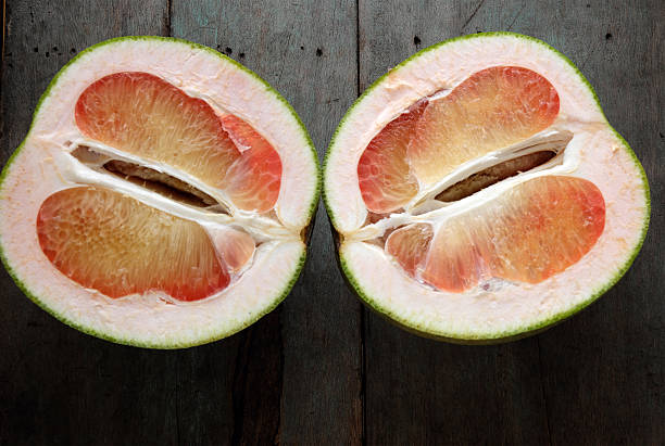 istock Grapefruit on wood background, tropical fruit 619515282