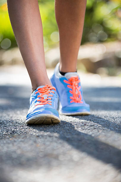 istock Woman jogging in park 619516044