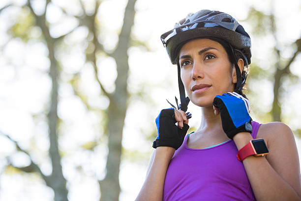 Female athletic wearing bicycle helmet Female athletic wearing bicycle helmet in countryside cycling helmet photos stock pictures, royalty-free photos & images