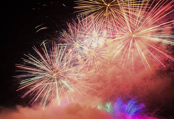 istock Fireworks light up the sky wit smoke. Colorful. 619516608