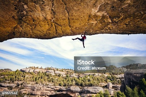 istock Woman rock climbing 619517442