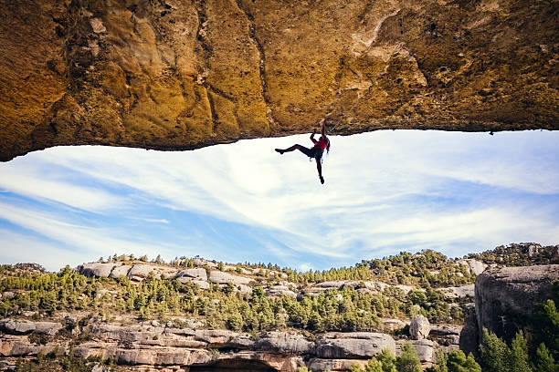 Woman rock climbing stock photo