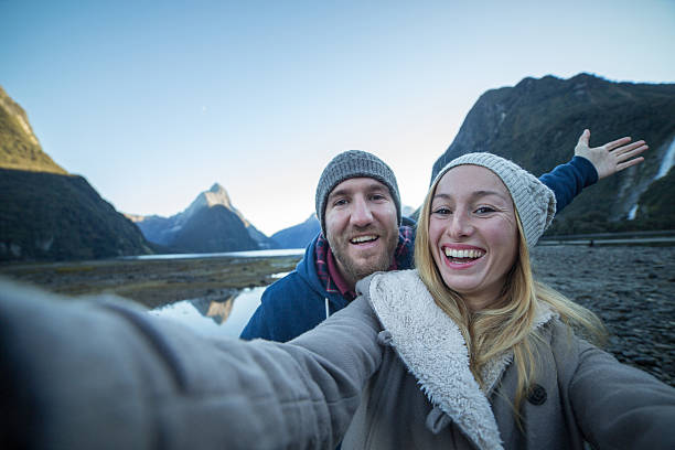 istock Young couple take selfie in mountain scenery, autumn 619517876