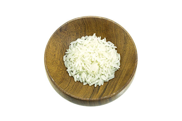 istock Rice in wood bowl on white background 619519484