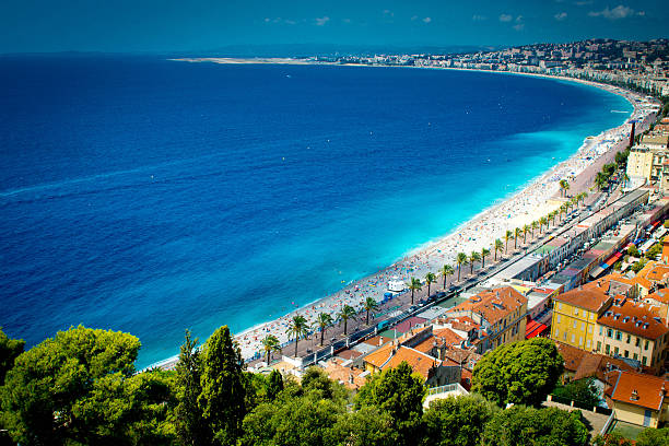 Nice France beach Nice, France - July 31, 2015: The beach on the Mediterranean sea in Nice, France.  This is on a hot July summers day with many holiday makers and tourists on the beach sunbathing. islamic state stock pictures, royalty-free photos & images