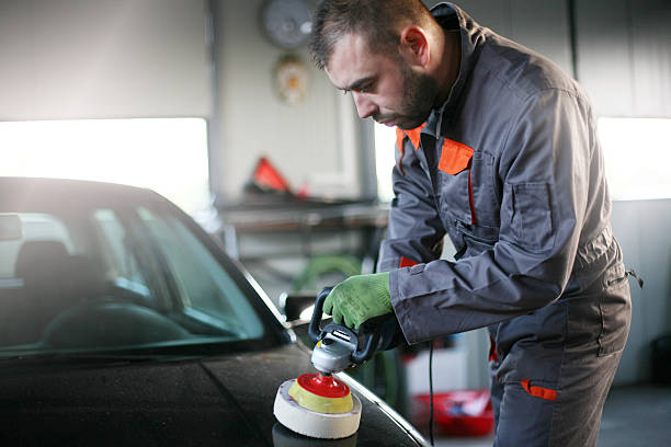 istock Mechanic polishing car. 619521304