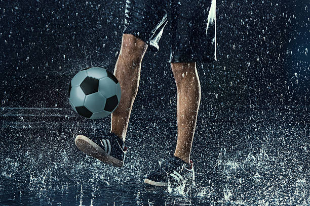 istock Water drops around football player 619521864