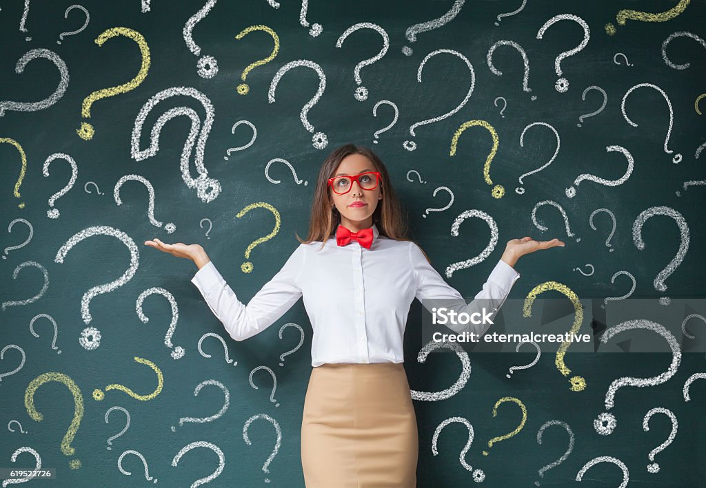 Businesswoman with question mark Business woman with question mark on a blackboard Question Mark Stock Photo