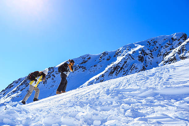 istock Side view of couple climbing up on mountain 619523568
