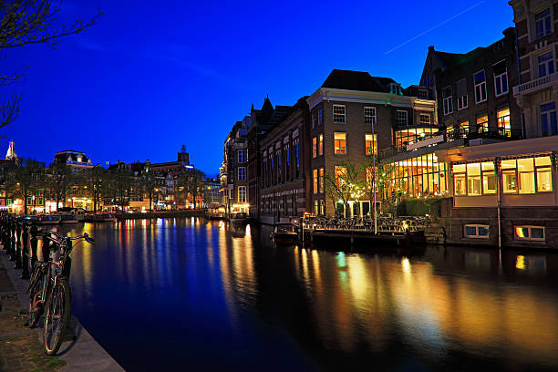 istock Bicycle Parked, Canals at night, Amsterdam, Netherlands 619524160