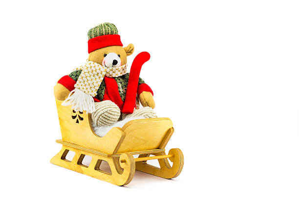 istock Christmas bear in wooden sleigh on white 619528028