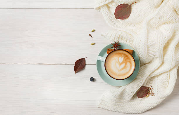istock Autumn cappuccino coffee cup on white wood background 619528218