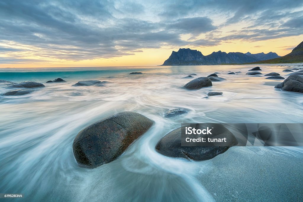 Uttakleiv Beach, Lofoten, Norway Lofoten is an archipelago and a traditional district in the county of Nordland, Norway. Lofoten is known for a distinctive scenery with dramatic mountains and peaks, open sea and sheltered bays, beaches and untouched lands. Nature Stock Photo