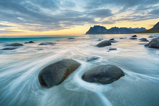 Uttakleiv Beach, Lofoten, Norway Lofoten is an archipelago and a traditional district in the county of Nordland, Norway. Lofoten is known for a distinctive scenery with dramatic mountains and peaks, open sea and sheltered bays, beaches and untouched lands. rock formation photos stock pictures, royalty-free photos & images