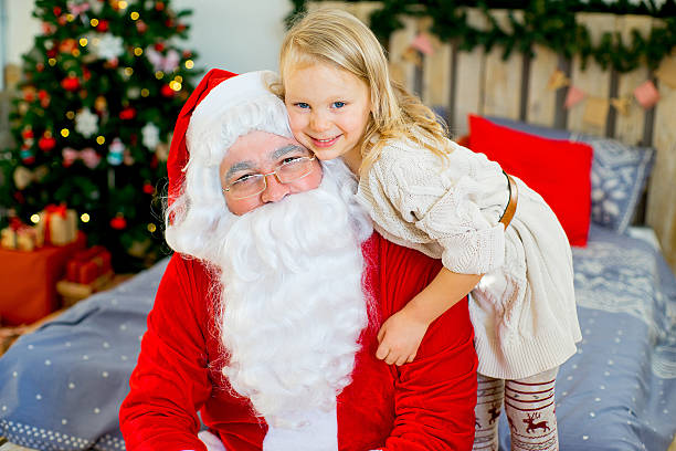 istock Santa Claus and cute girl getting ready for Christmas 619528646