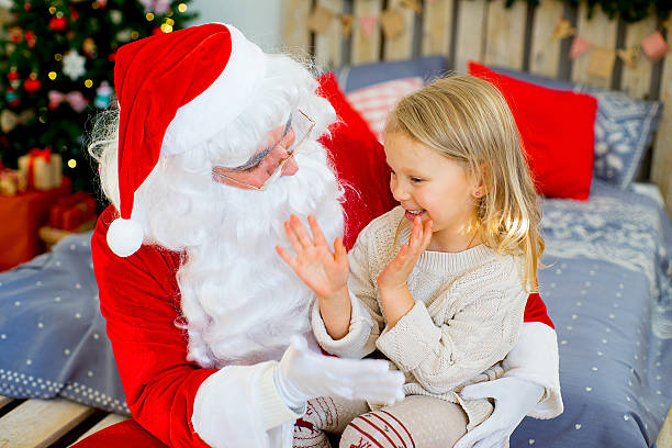 istock Santa Claus and cute girl getting ready for Christmas 619528758