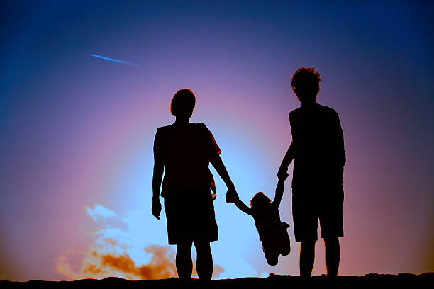 istock happy family with small child play at sunset 619528790