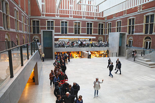 Amsterdam, Netherlands - May 3, 2016: Tourist buying tickets at Rijksmuseum lobby, Amsterdam, Netherlands