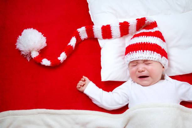 istock Sleepy baby on red blanket 619530720