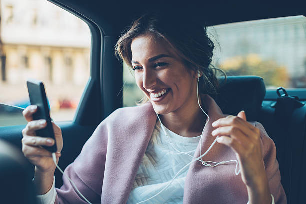 Woman with mobile phone in a car