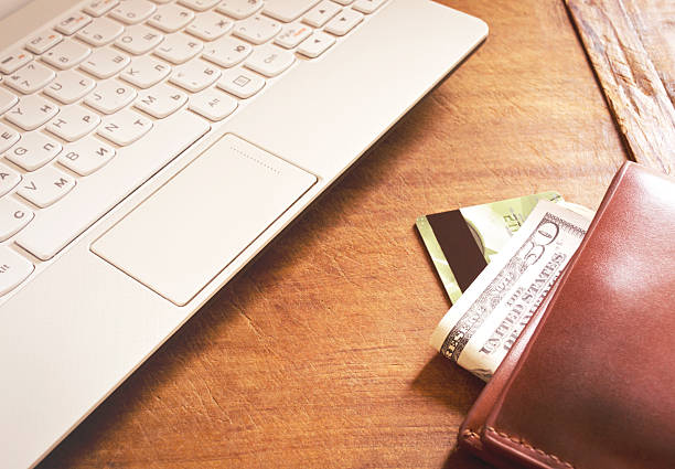 istock Working desk with laptop and wallet 619530998