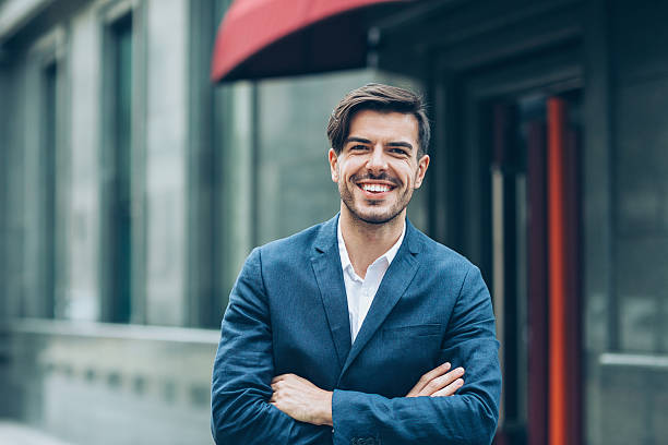 istock Smiling businessman with arms crossed 619531120
