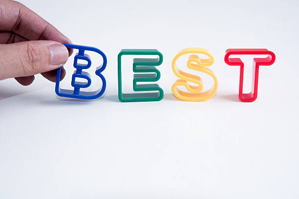 hand hold plastic alphabet on white background with word best