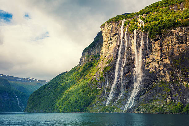 Geiranger fjord. Seven Sisters Waterfall, Norway Geiranger fjord. Seven Sisters Waterfall, Norway. Mountain landscape with cloudy sky. Beautiful nature. geirangerfjord stock pictures, royalty-free photos & images