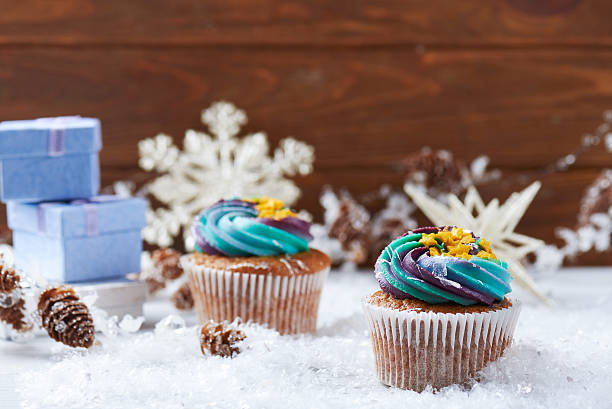 istock Wintery cupcakes on a snow background 619534086