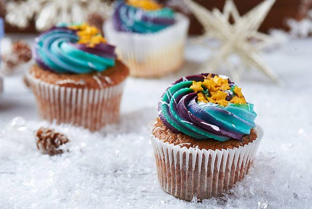 istock Wintery cupcakes on a snow background 619534226