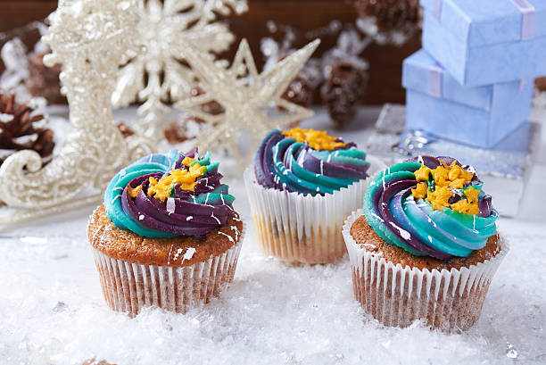 istock Wintery cupcakes on a snow background 619534944