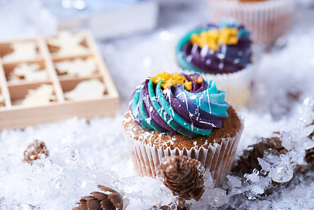 istock Wintery cupcakes on a snow background 619535106