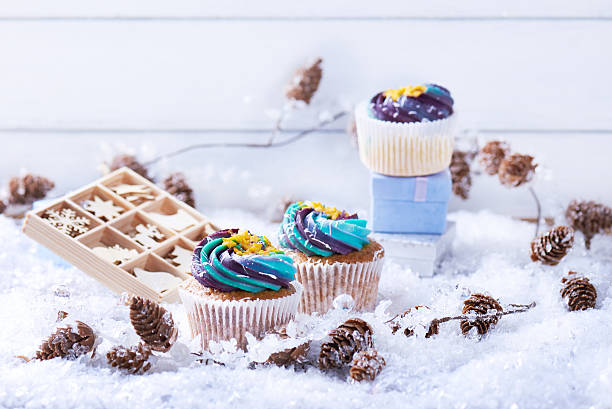 istock Wintery cupcakes on a snow background 619535244