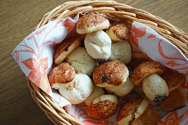 Photo of Christmas cookies mushrooms in a basket on a wooden table