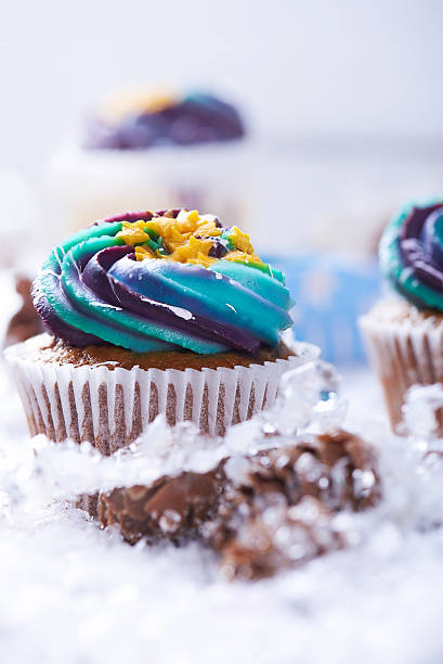 istock Wintery cupcakes on a snow background 619535606